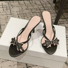 Black bow accent heeled slides with stiletto heel
