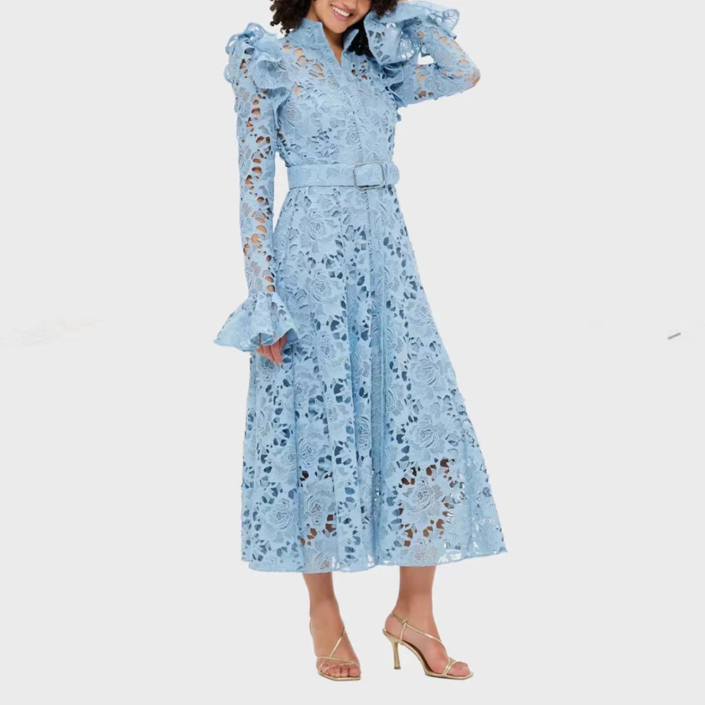 Woman wearing a light blue lace dress with ruffled sleeves on a white background