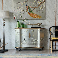 Decorative cabinet with peacock painting and floral elements in a room setting.