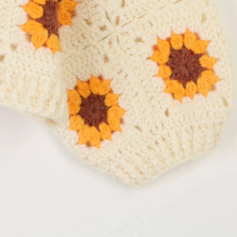Close-up of a crocheted square with sunflower patterns 