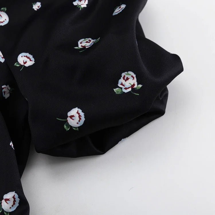 Black fabric with white floral patterns on a white background