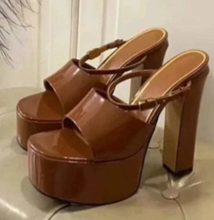 Brown platform sandals on a light surface with a neutral background