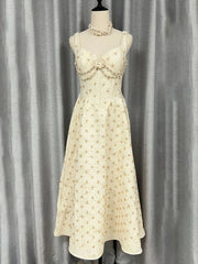 Sleeveless A-line ankle dress in textured cream fabric with subtle motifs