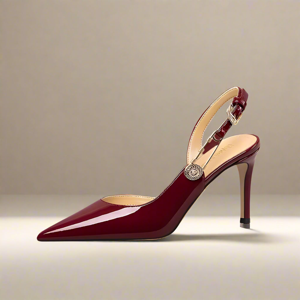 Maroon high-heeled shoe with a strap on a light gray background