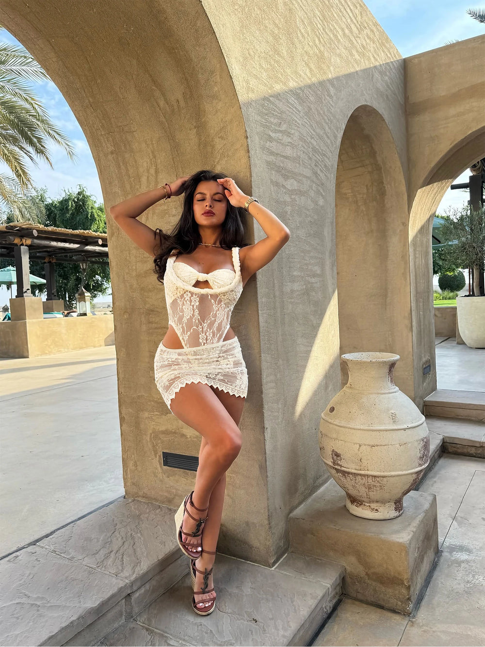 White lace bikini set with bow detail and mini skirt