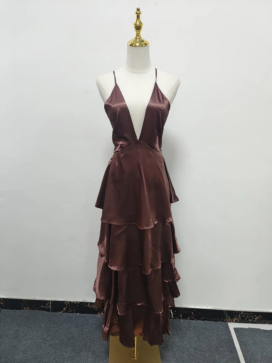 Brown tiered dress on a mannequin against a white wall.