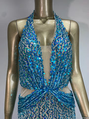 Women's sequin halter dress with adjustable straps.