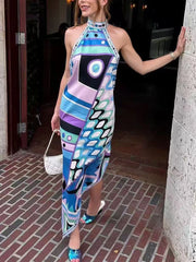 Model wearing a colorful abstract print halter neck maxi dress