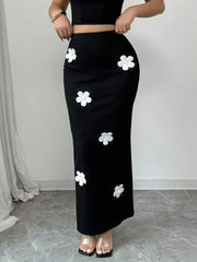 Black outfit with white floral patterns on a plain background