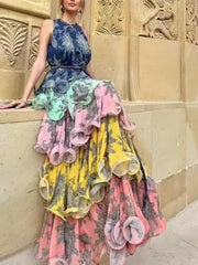 Woman wearing a colorful, layered dress against an ornate wall.