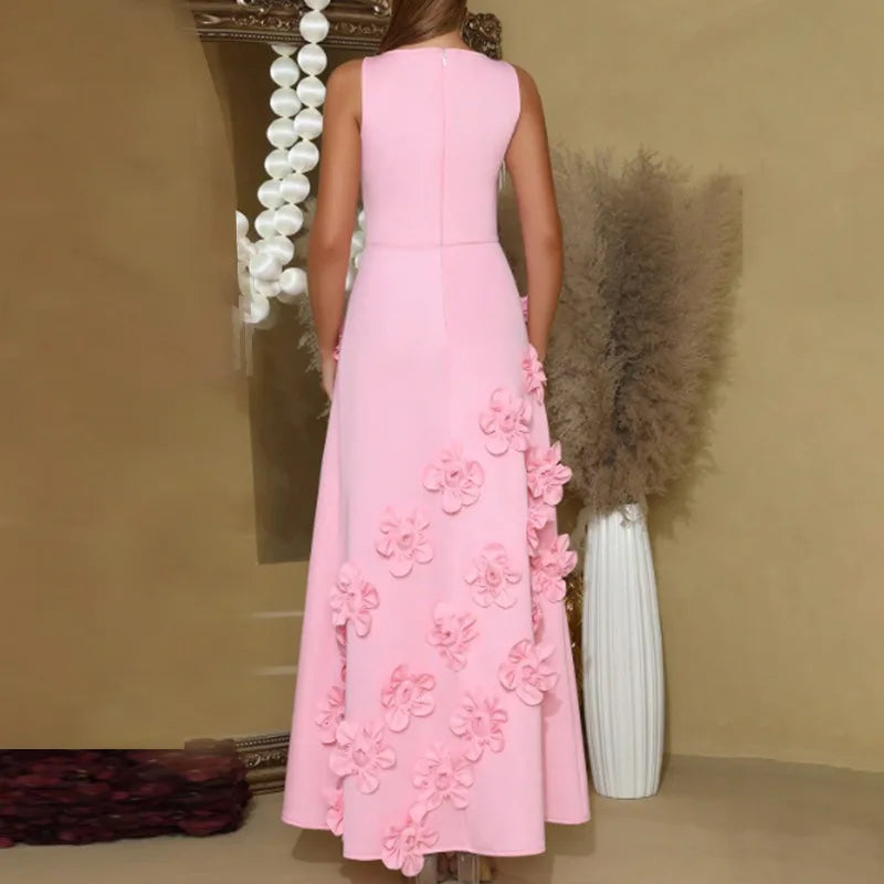 Pink dress with floral details worn by a person against a beige wall.