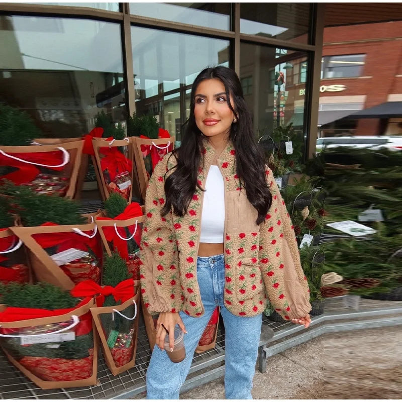 Person wearing a beige floral print plush fleece jacket with blue jeans.