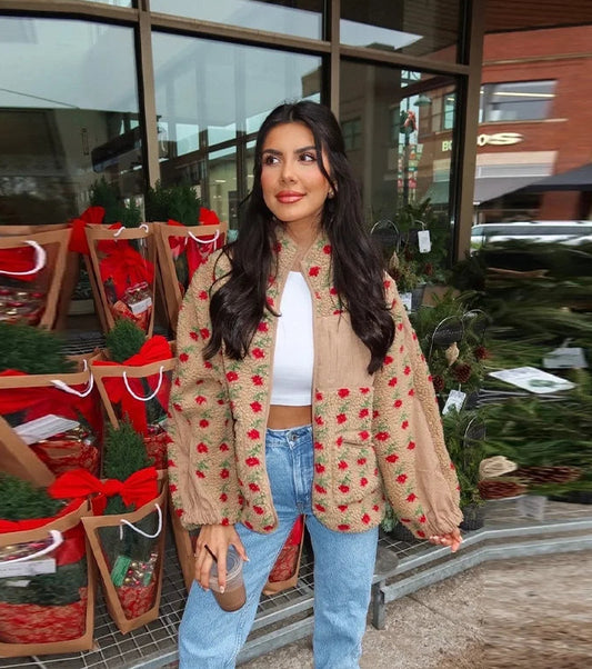 Person wearing a beige floral print plush fleece jacket with blue jeans.