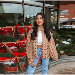 Person wearing a beige floral print plush fleece jacket with blue jeans.