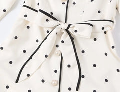 Close-up of the polka dot notched collar coat tie sash