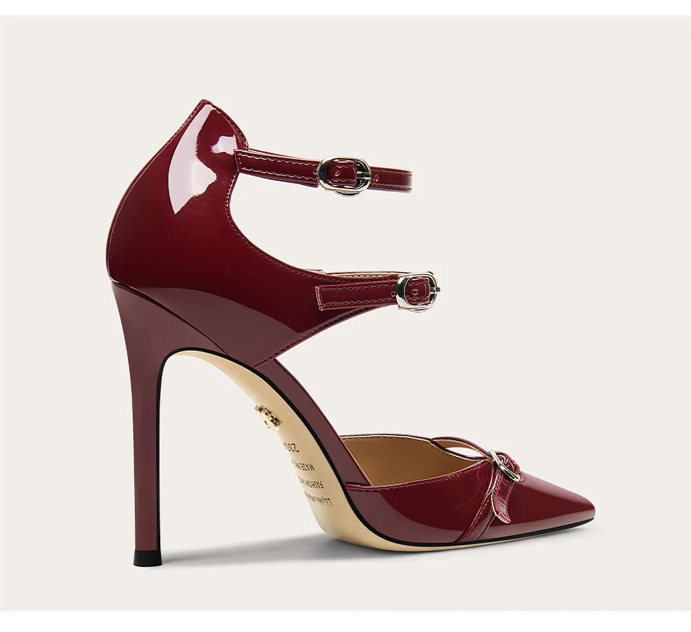 Maroon high-heeled shoe with a strap on a light beige background
