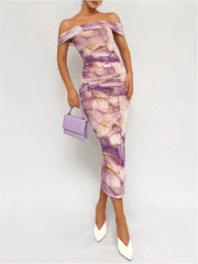 Woman wearing a floral off-shoulder dress with a matching handbag on a white background
