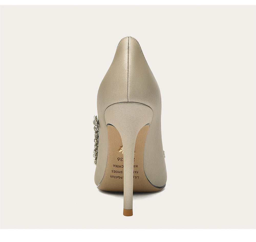Beige high-heeled shoe with a stiletto heel on a white background
