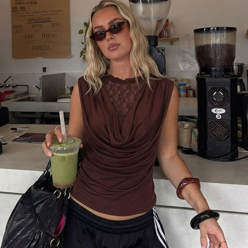Woman holding a green smoothie in a coffee shop