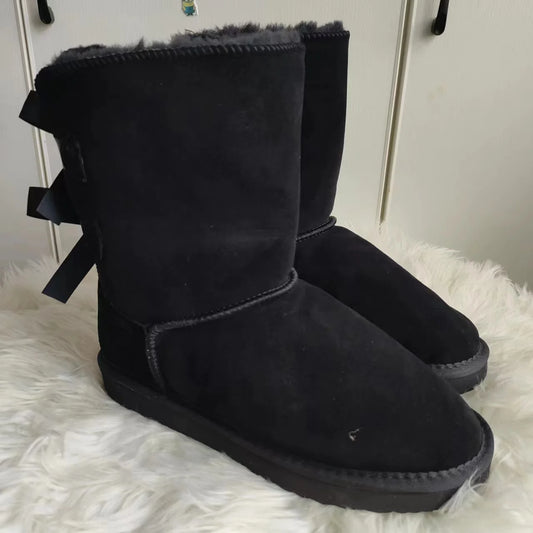 Black plush snow boots with ribbon bows