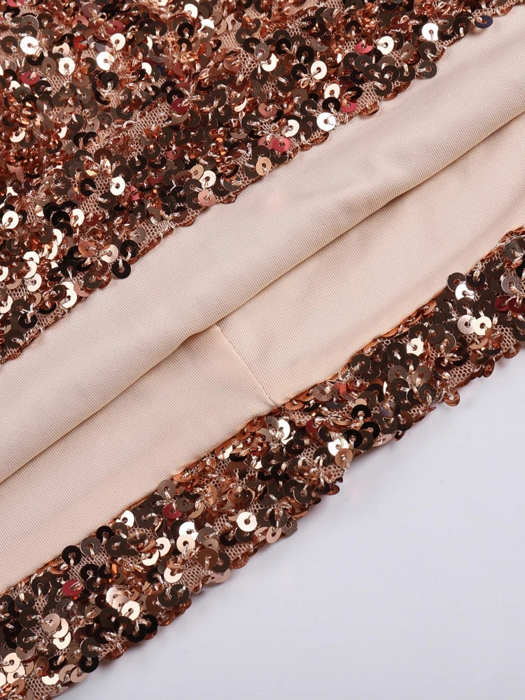 Close-up of rose gold sequin trim on beige fabric