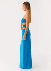 Woman wearing a blue strapless gown with cut-out design on a white background