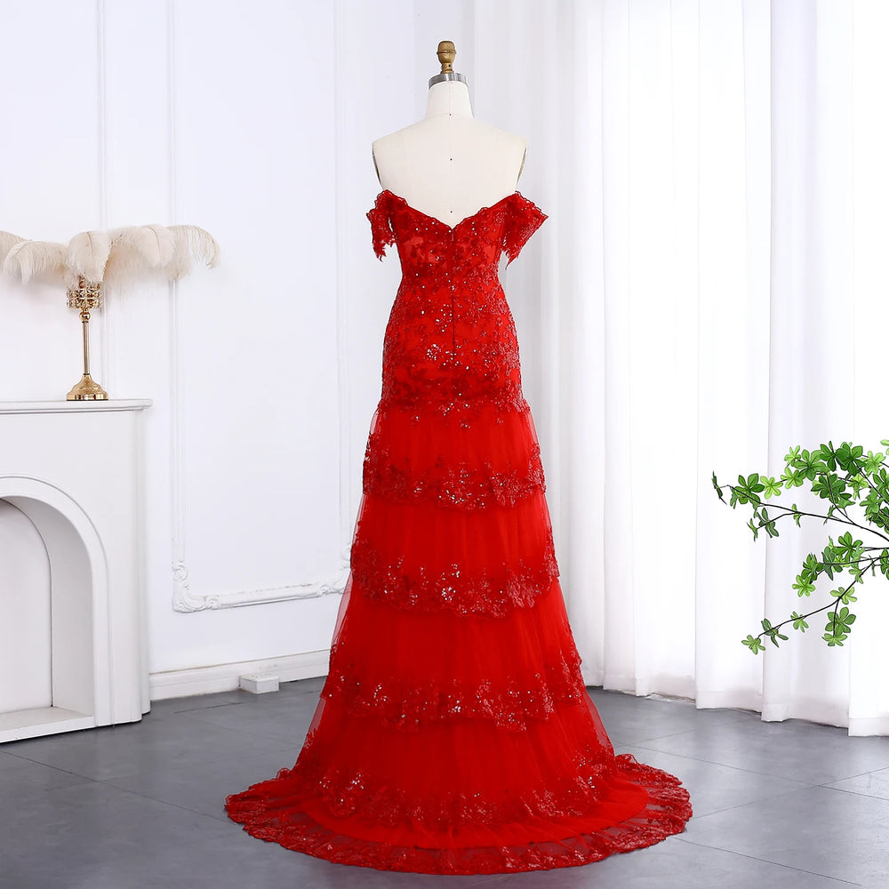 Red evening gown on a mannequin against a white curtain background