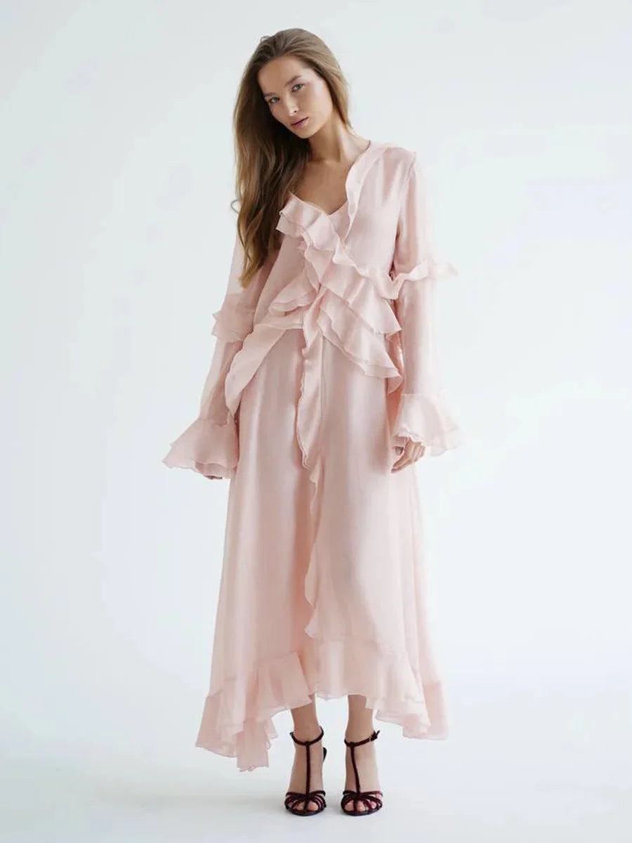 Woman wearing a pink ruffled dress on a white background