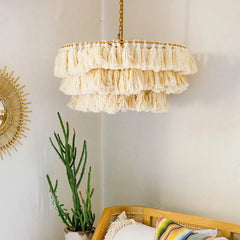 A dining room illuminated by a Fela Tassel Chandelier, creating a cozy and inviting atmosphere. Beige A