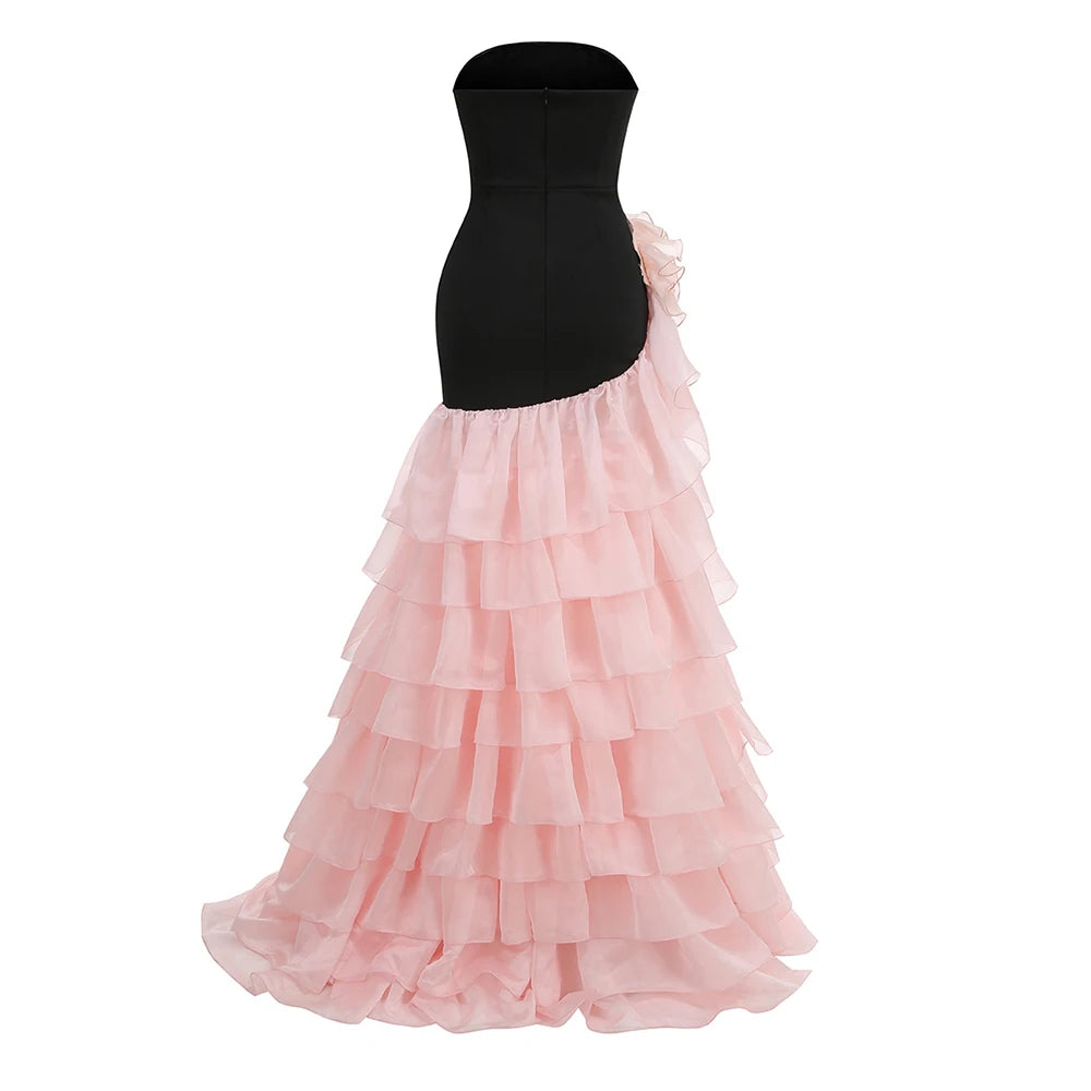 Black bodice with a pink ruffled skirt on a white background