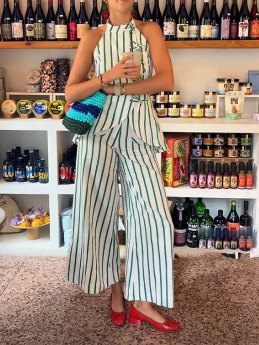 Person wearing a green and white striped outfit in a store setting with shelves of products.
