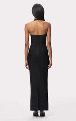 Back view of a black bandage gown with a halter neckline and crystal bodice