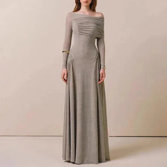 Long gray dress with one shoulder on a plain background