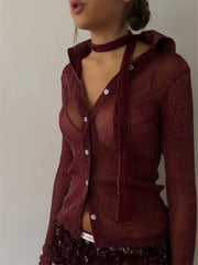 Maroon cardigan with sheer overlay worn by a person on a neutral background