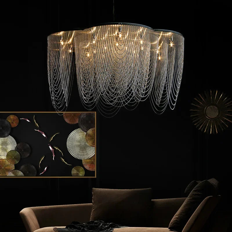 Black steel chandelier with chain tassel, floral design and dimmable LEDs illuminating modern, moody lounge