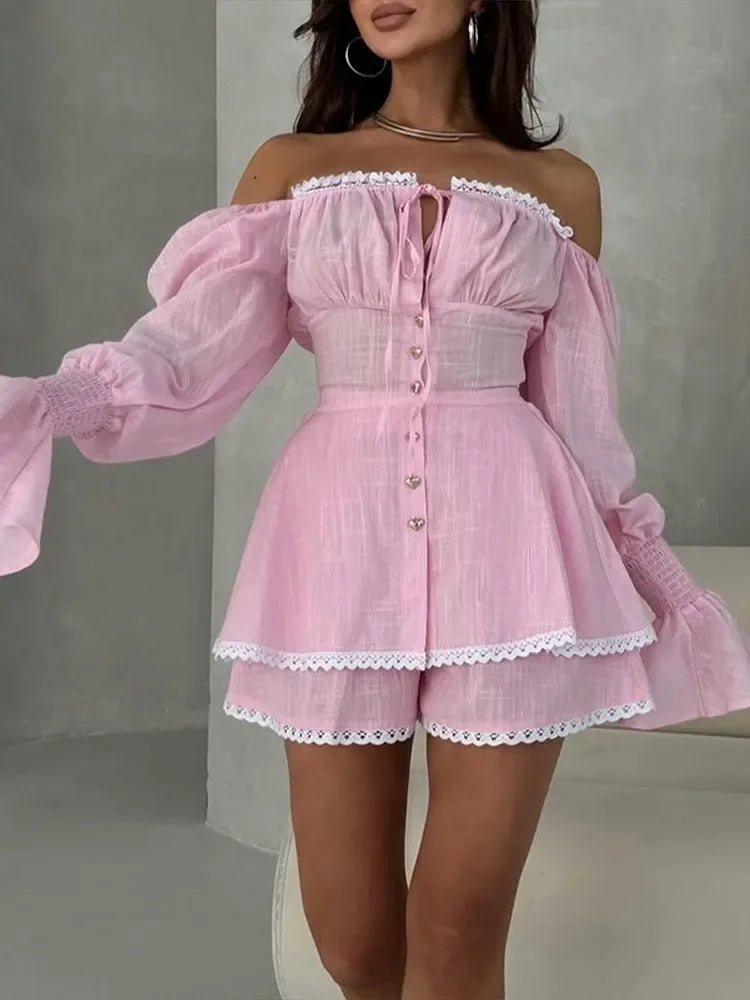 Pink off-shoulder dress with lace details on a neutral background