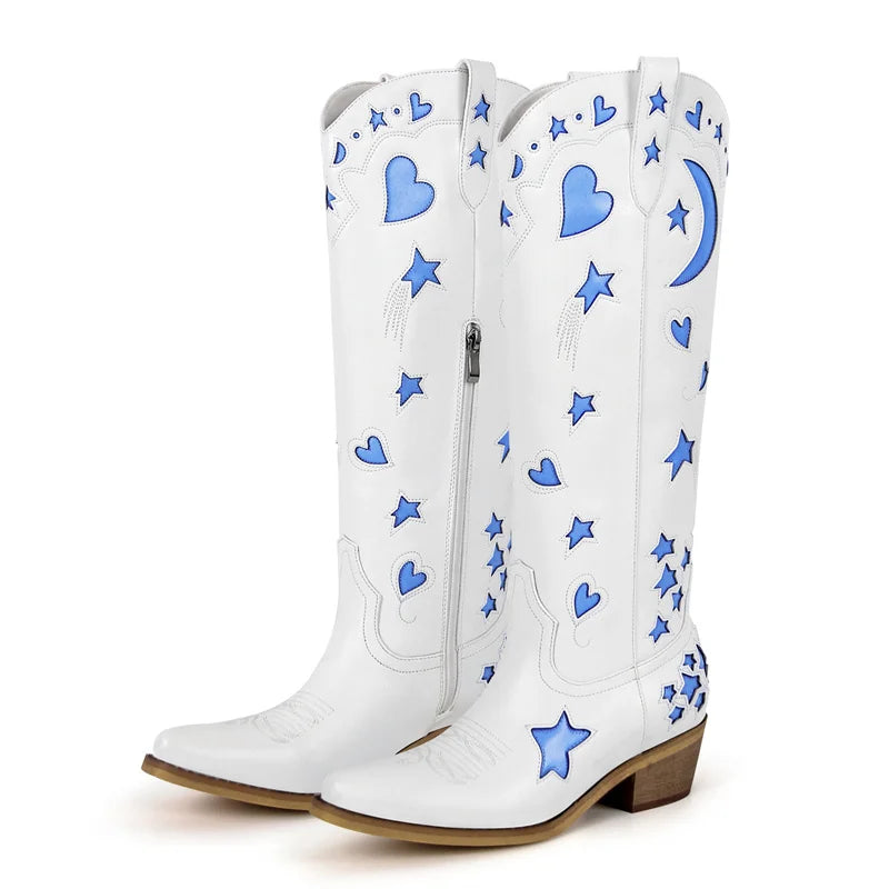 White cowboy boots with blue heart and star patterns on a white background