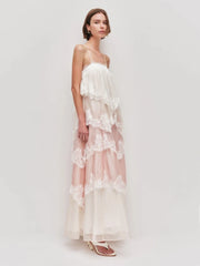 Woman wearing a white lace dress on a light gray background