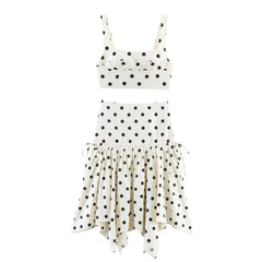 White dress with black polka dots on a white background