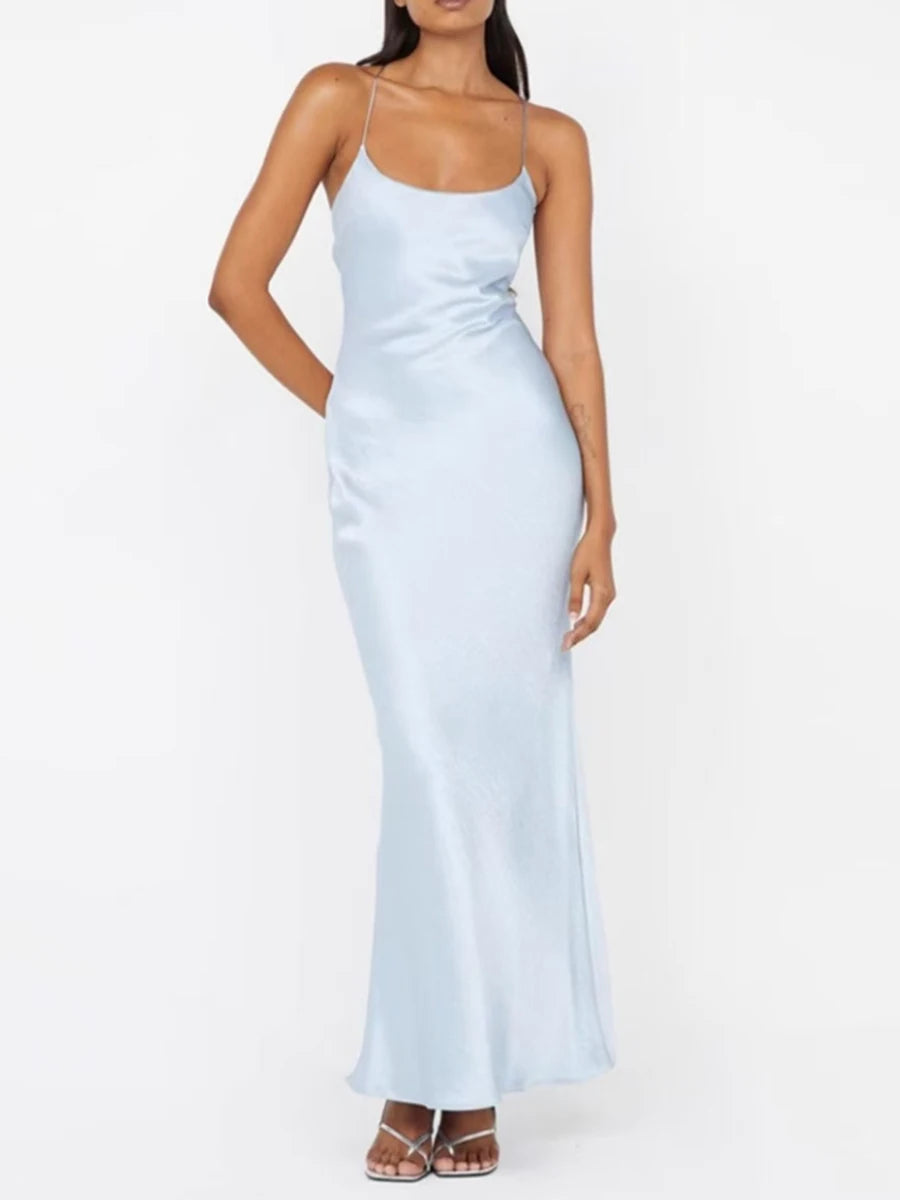 Woman wearing a light blue slip dress on a white background