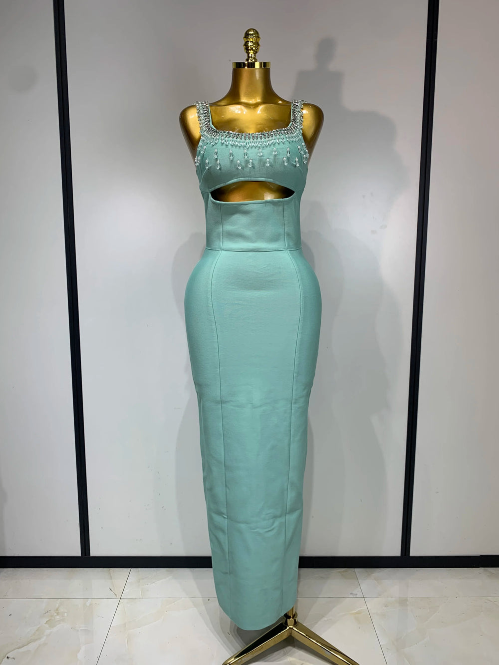 Sleeveless column dress with a beaded square neckline and waist cutout