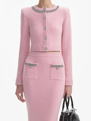 Pink outfit with decorative elements on a white background