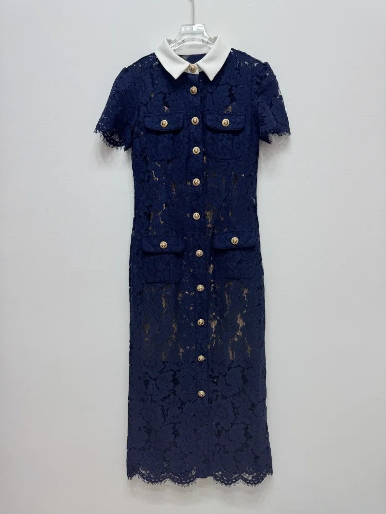 Navy lace dress with gold buttons on a white hanger against a light gray background