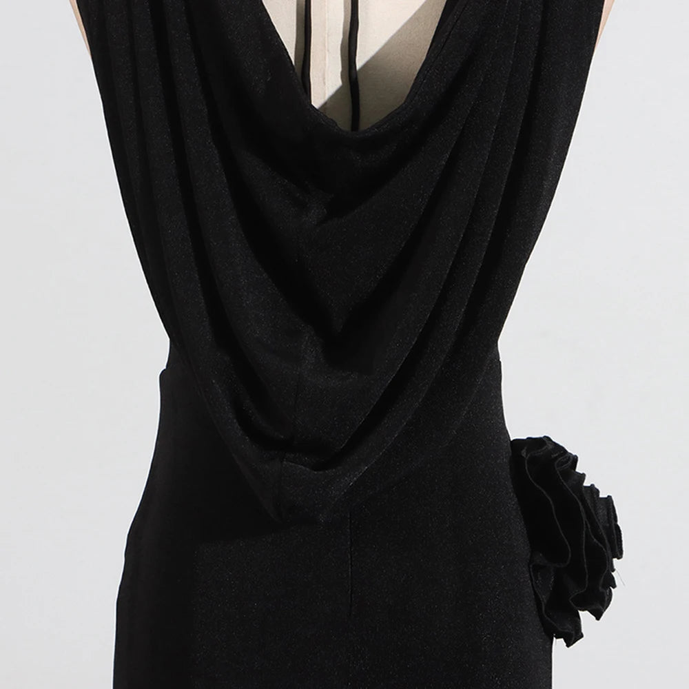 Black dress with a floral detail on a light gray background