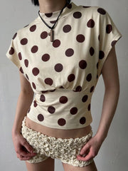 Detail view of a polka dot drop-shoulder crop top
