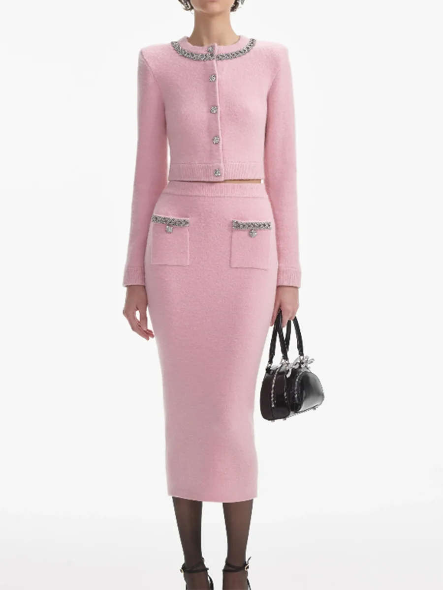Woman wearing a pink outfit with decorative elements on a white background