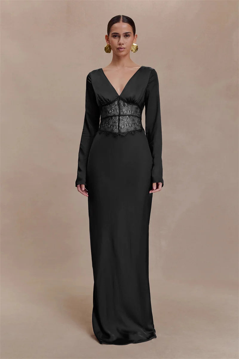 Woman wearing a black evening gown with a corset detail on a beige background