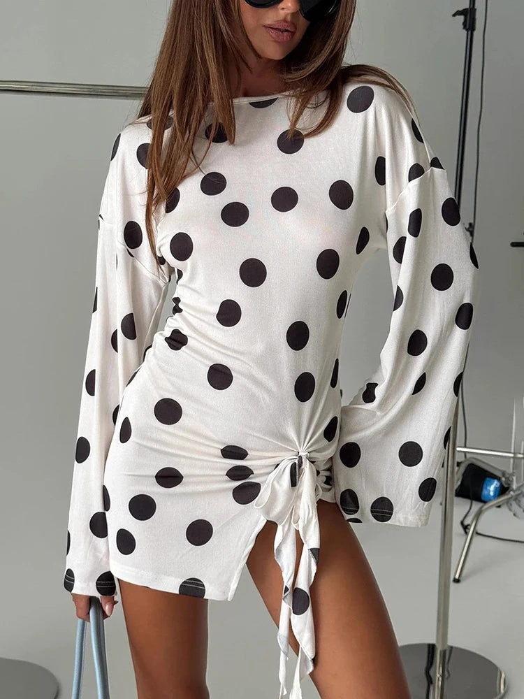 Close-up of the polka dot print on a ruched mini dress