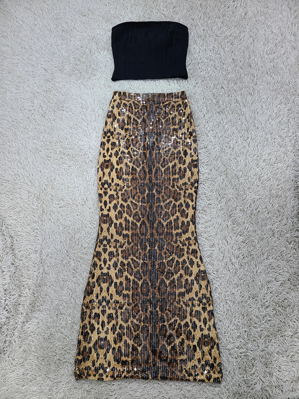 Black tube top and leopard print skirt on a gray surface