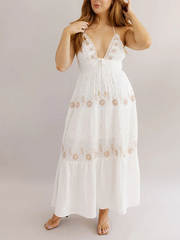 White lace dress with floral patterns on a plain background